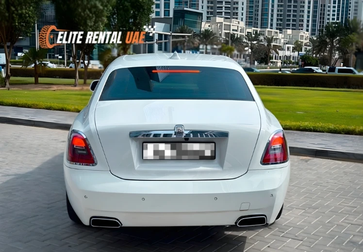 Back view of white Rolls Royce Ghost highlighting luxury rear design for rental