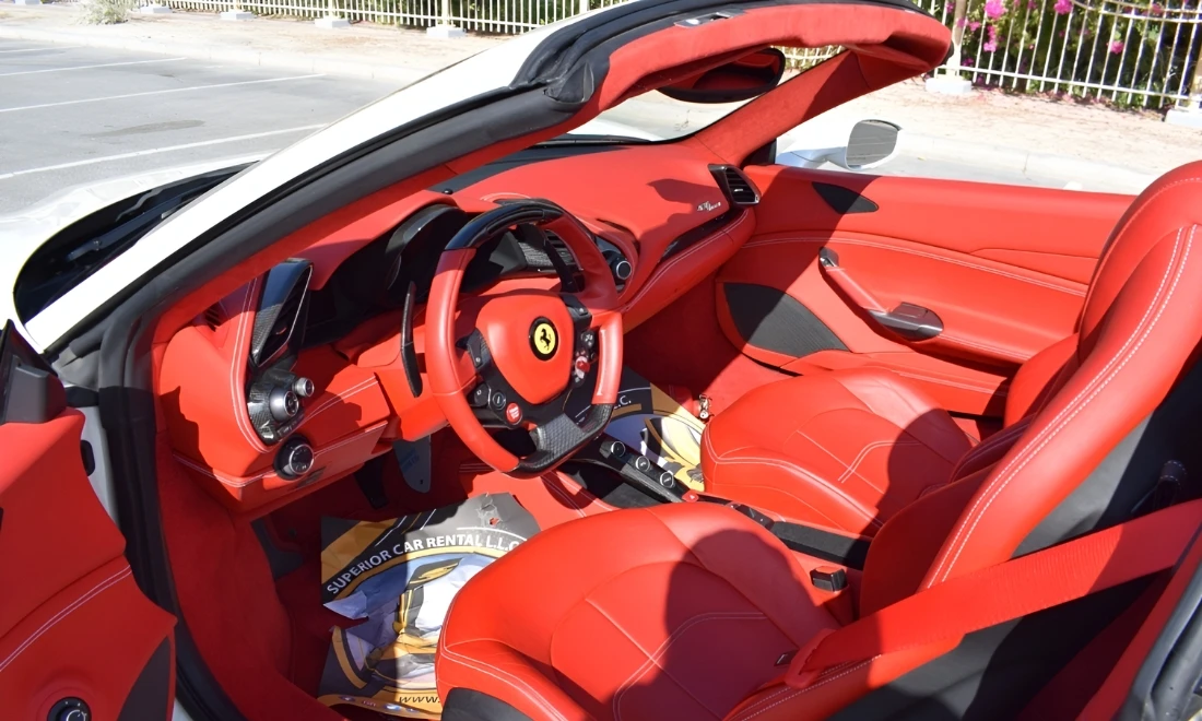 Orange Ferrari 488 Spider cockpit interior with premium sports cabin luxury car rental Dubai UAE